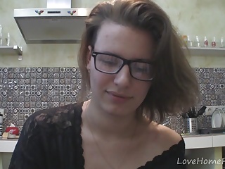 Solo girl with glasses chatting in the kitchen 